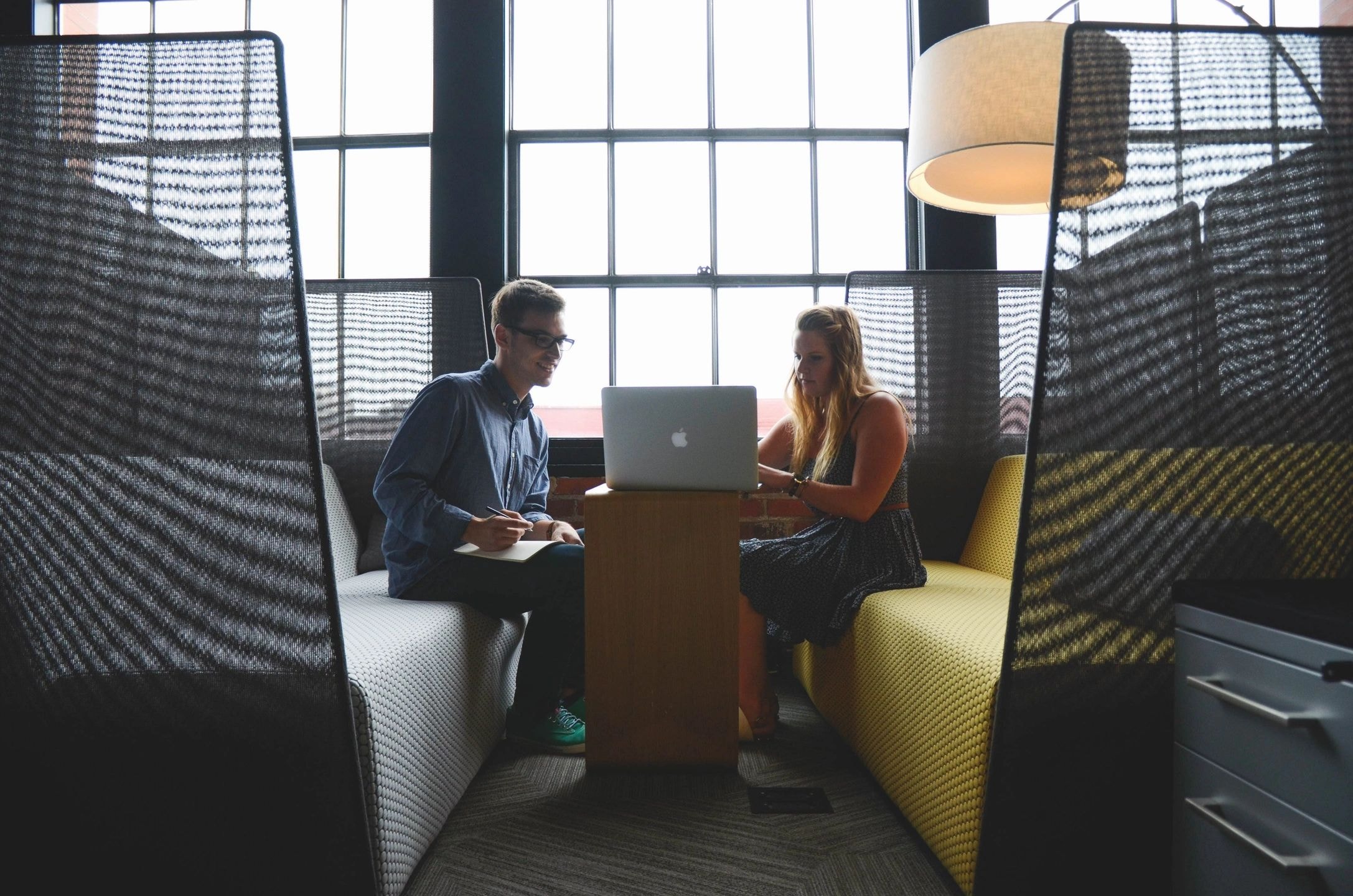 Two professionals collaborating on laptop