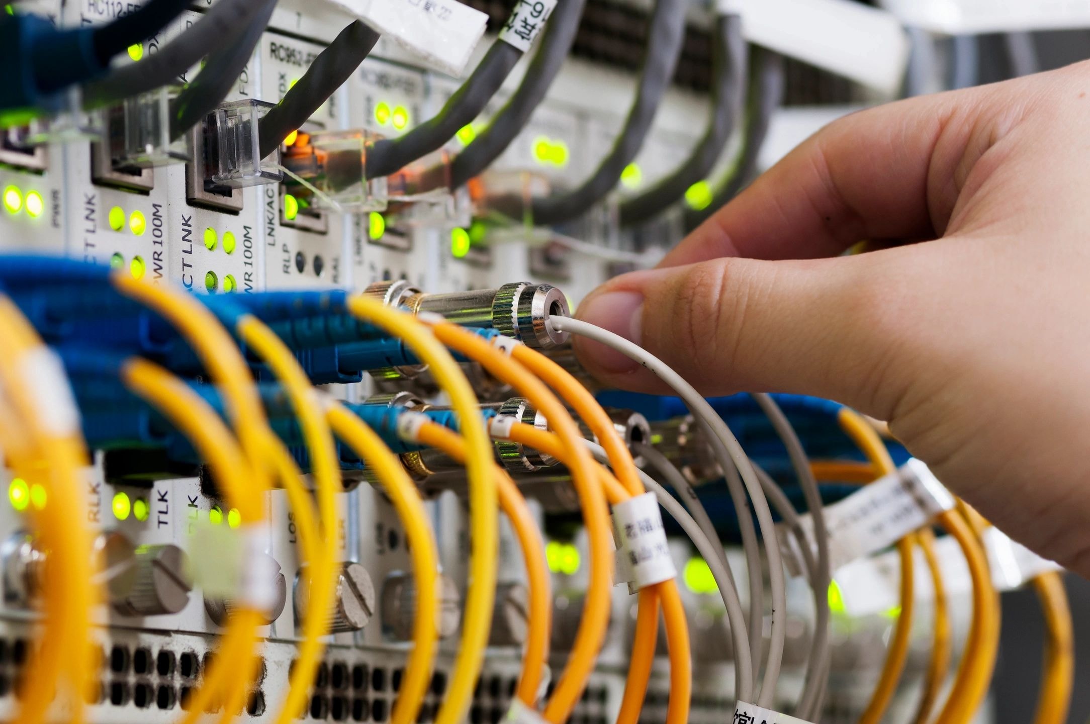 Technician connecting fiber optic network cables